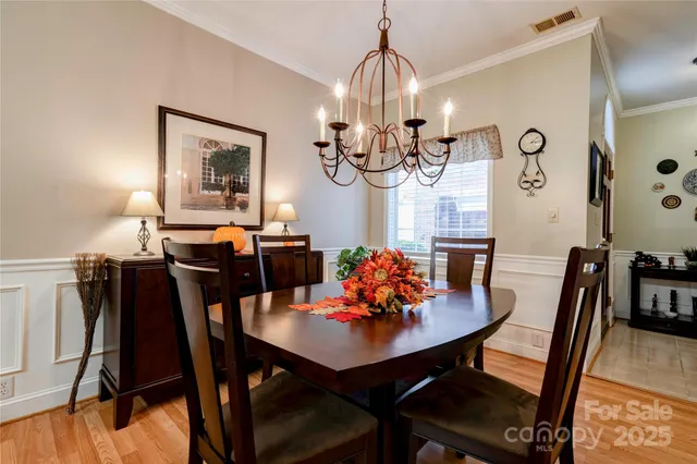 a view of a dining room with furniture and chandelier