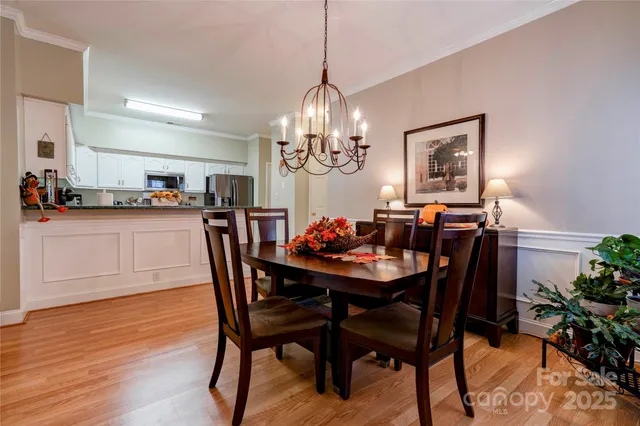 a view of a dining room with furniture wooden floor and chandelier