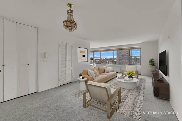 a living room with furniture a window and a flat screen tv