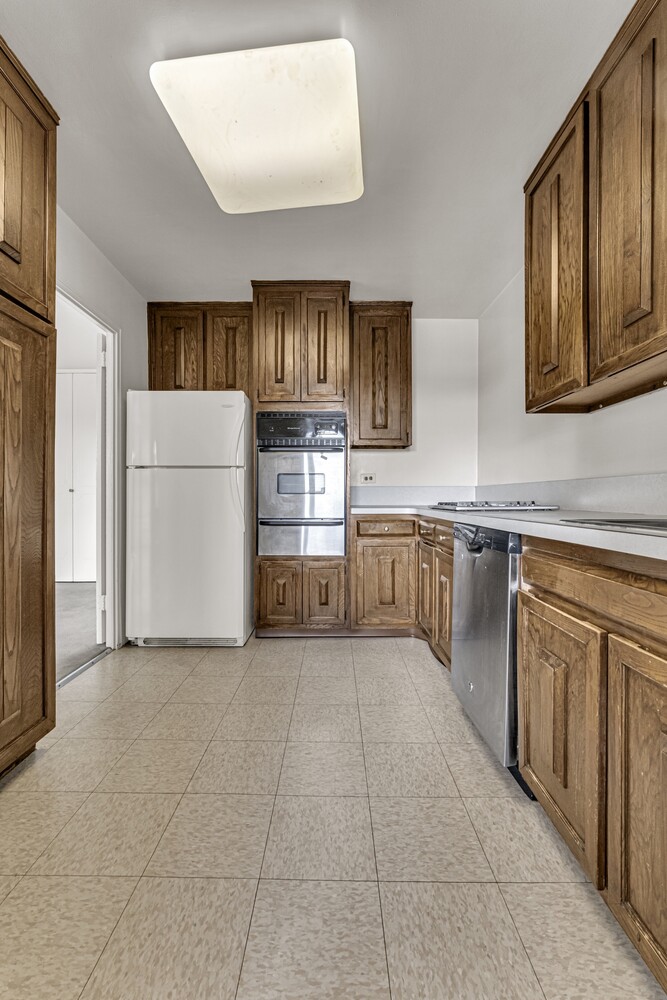 2500 Johnson Avenue, Unit 6T Bronx, NY 10463 - Photo 5 of 8 a kitchen with cabinets and a refrigerator