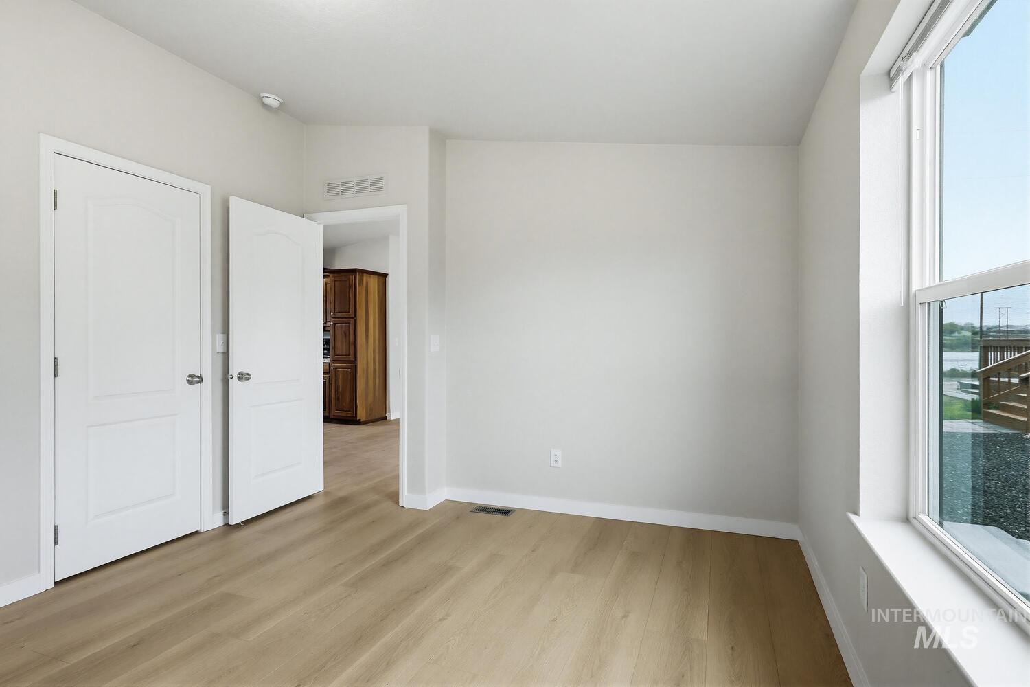166 1st Street North Marsing, ID 83639 - Photo 16 of 37 Unfurnished bedroom with light wood finished floors and lofted ceiling