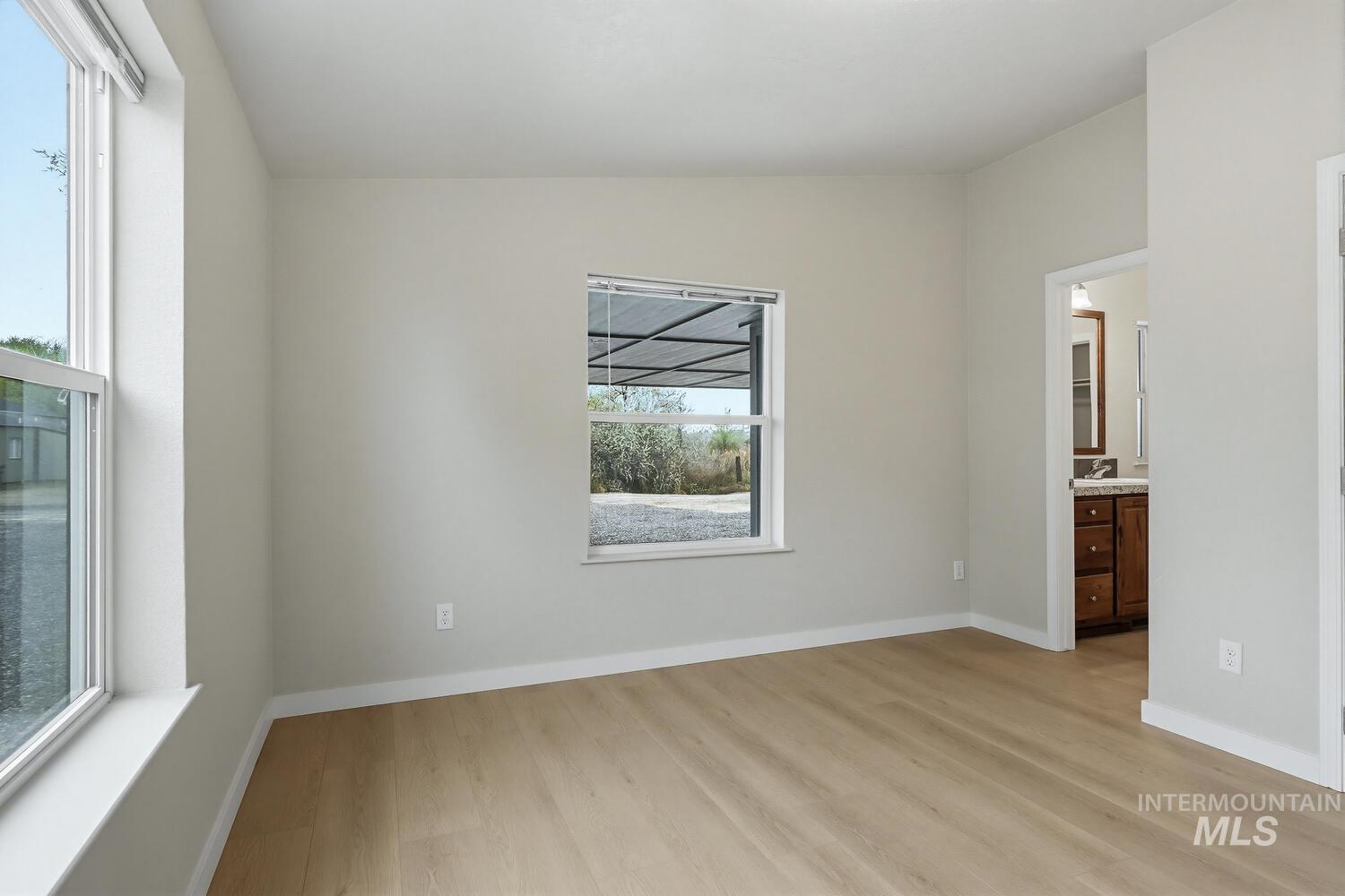 166 1st Street North Marsing, ID 83639 - Photo 17 of 37 Unfurnished bedroom featuring light wood-style floors and ensuite bathroom