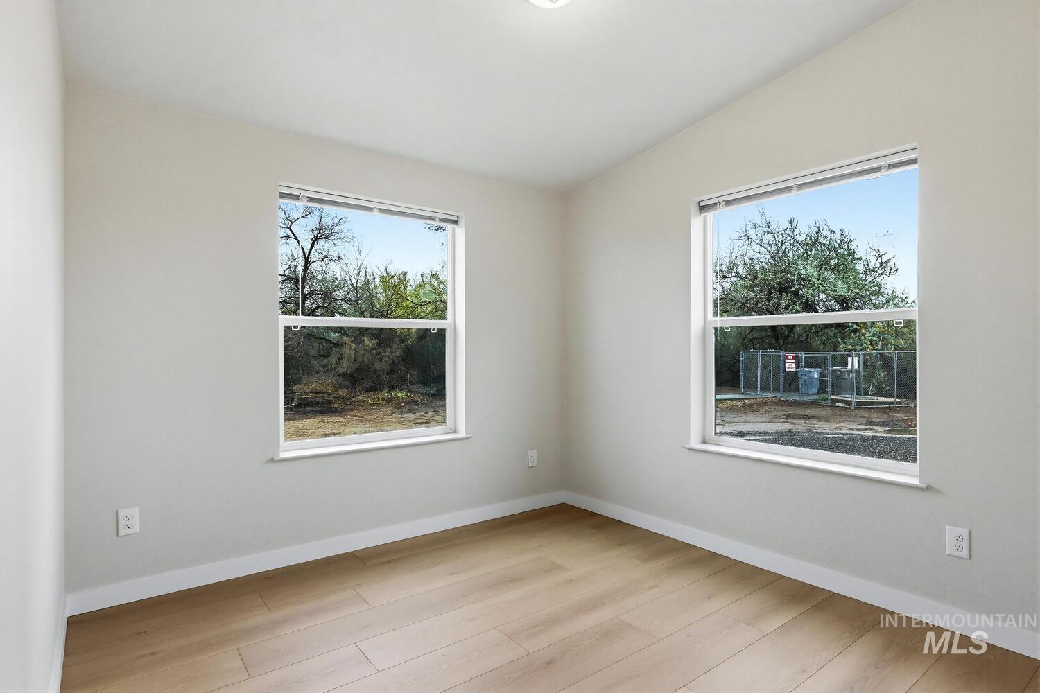 166 1st Street North Marsing, ID 83639 - Photo 20 of 37 Empty room featuring light wood-type flooring, vaulted ceiling, and plenty of natural light