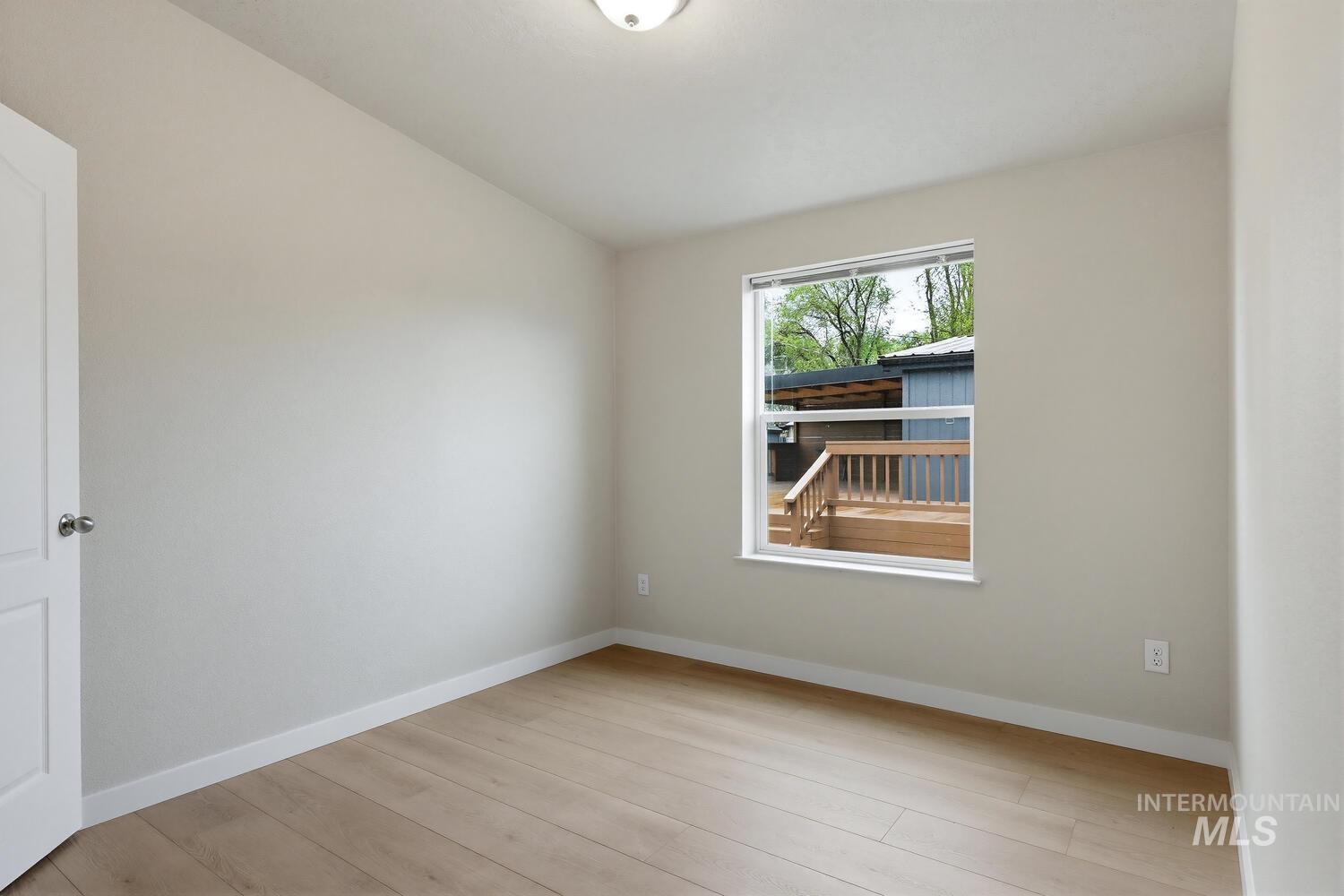 166 1st Street North Marsing, ID 83639 - Photo 23 of 37 Unfurnished room with light wood-style floors and vaulted ceiling