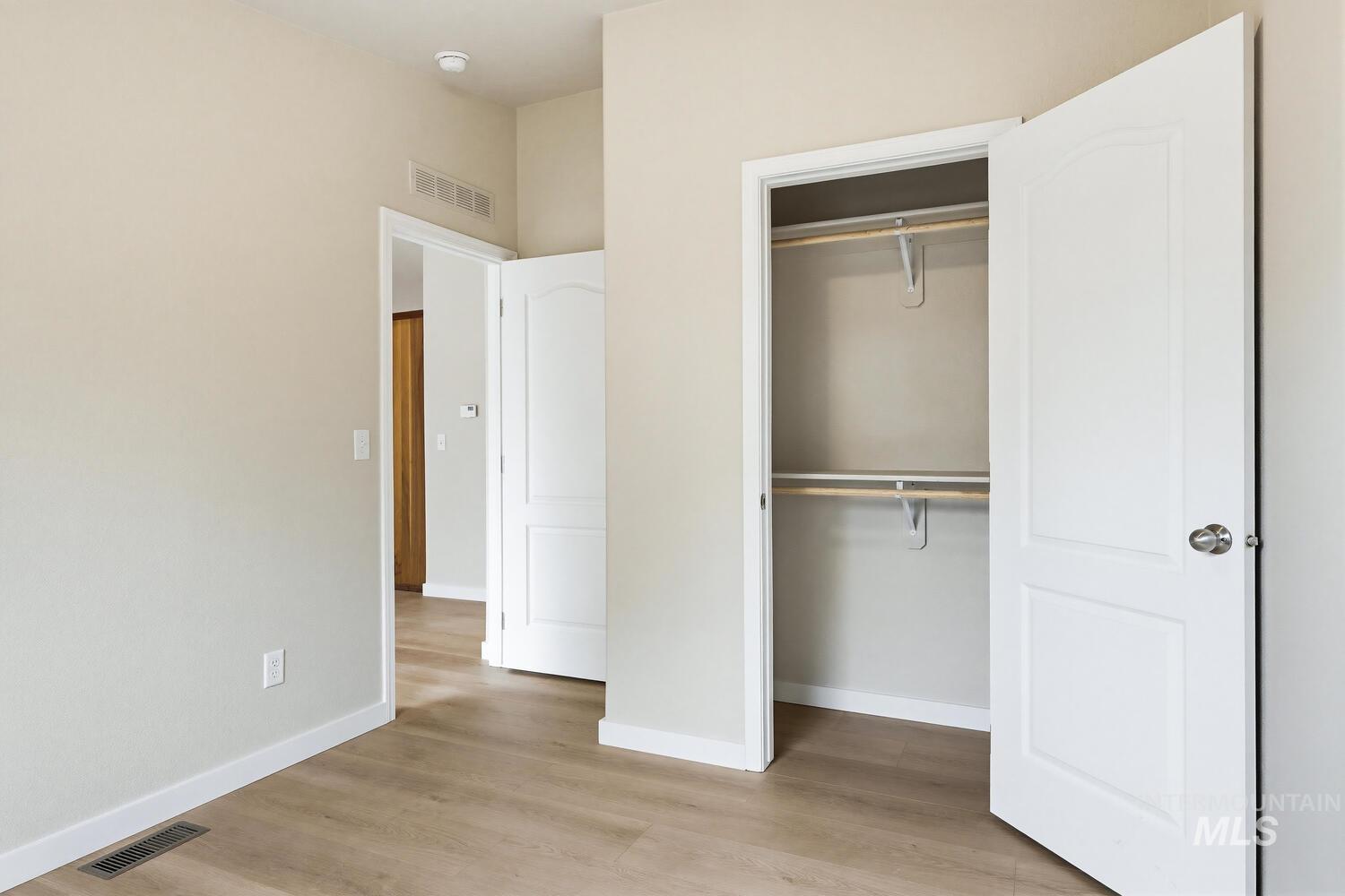 166 1st Street North Marsing, ID 83639 - Photo 24 of 37 Unfurnished bedroom with light wood-style floors and a closet