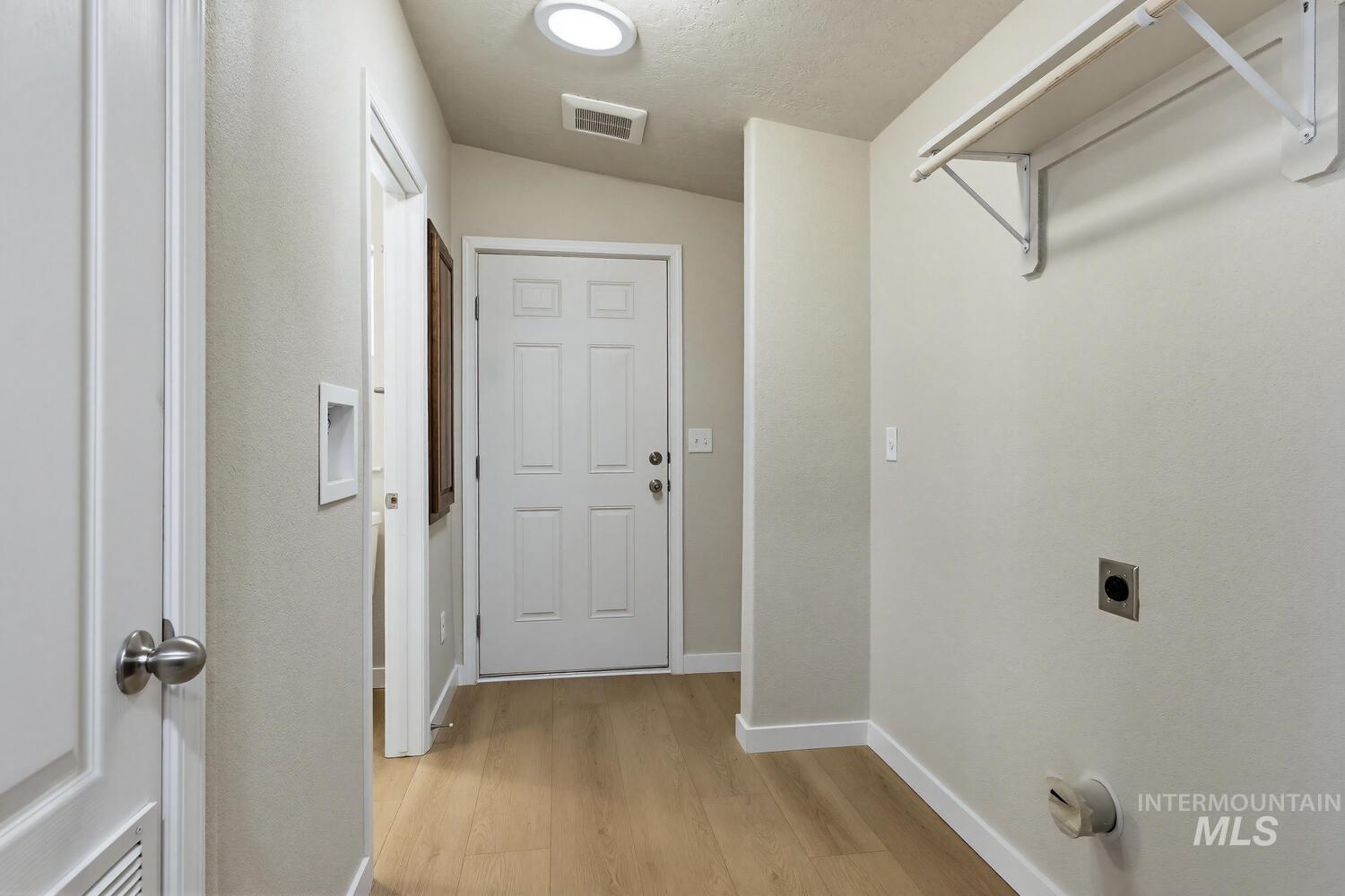 166 1st Street North Marsing, ID 83639 - Photo 25 of 37 Laundry area featuring hookup for an electric dryer, light wood-style floors, and a textured ceiling