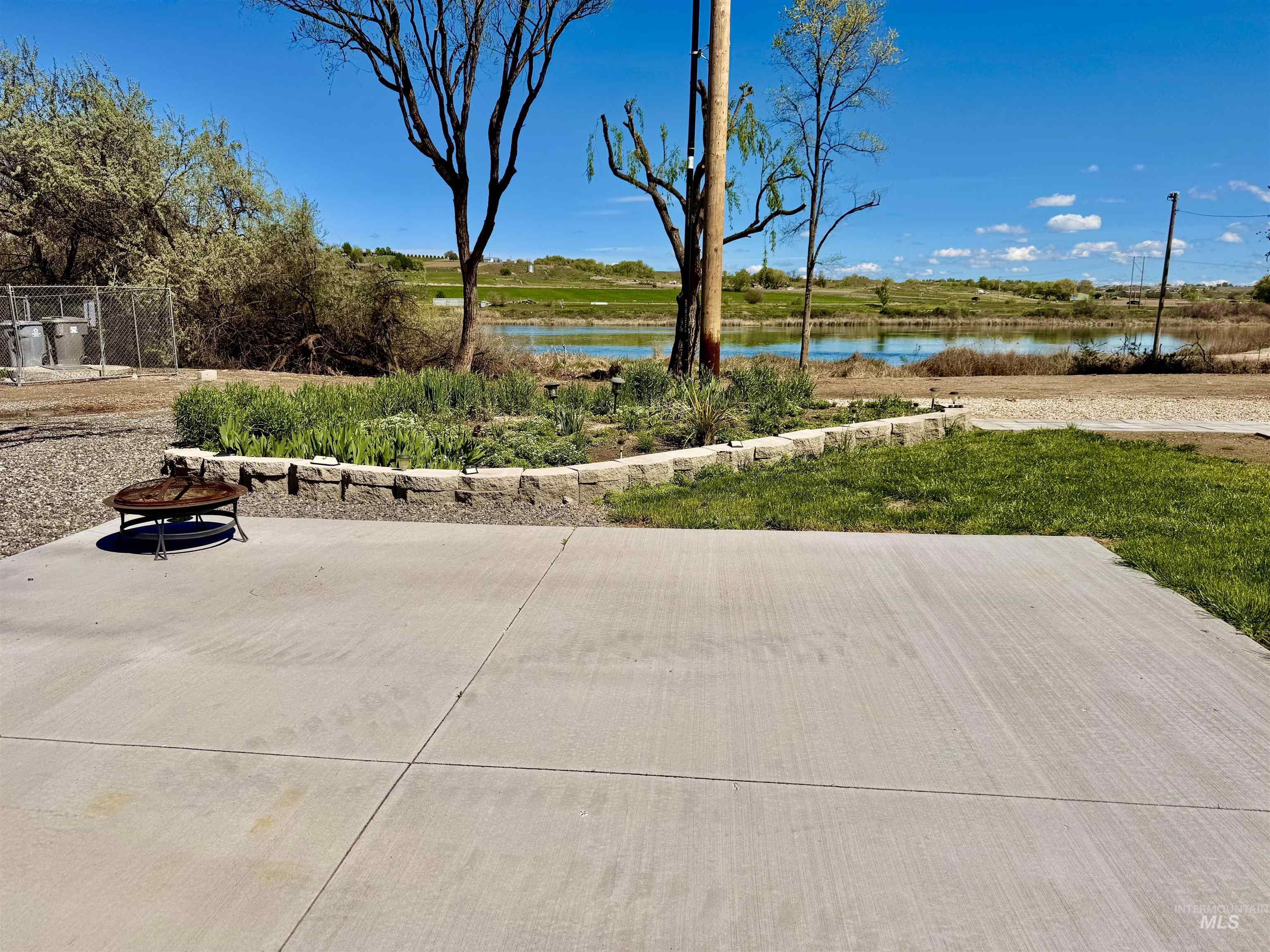 166 1st Street North Marsing, ID 83639 - Photo 28 of 37 View of patio / terrace featuring a fire pit and a water view