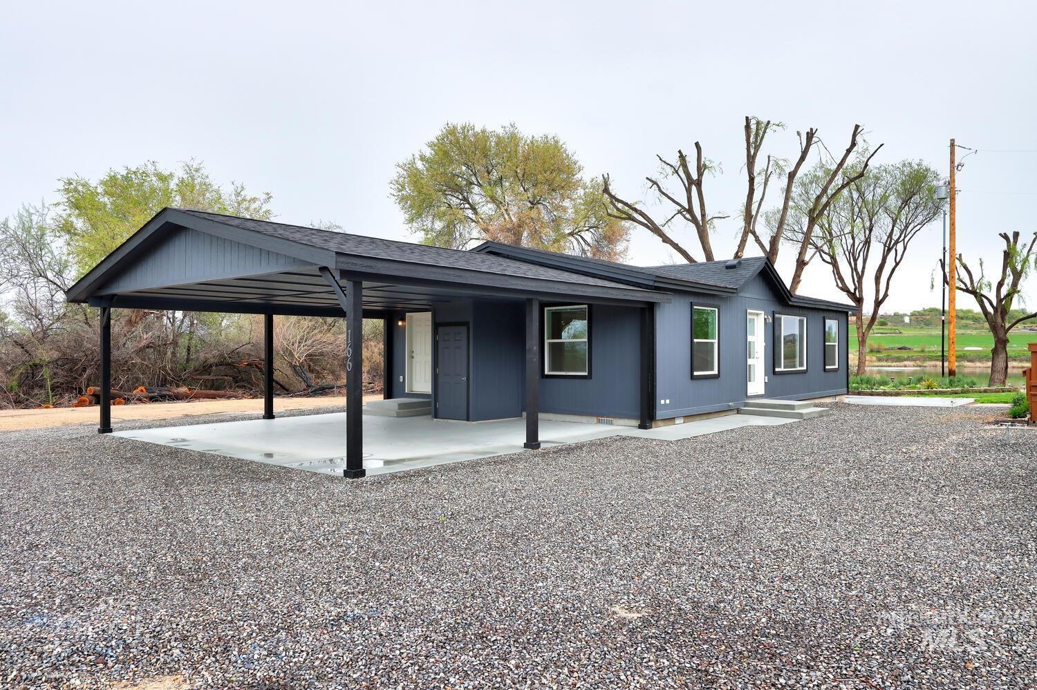 166 1st Street North Marsing, ID 83639 - Photo 3 of 37 Back of house with a shingled roof and a carport