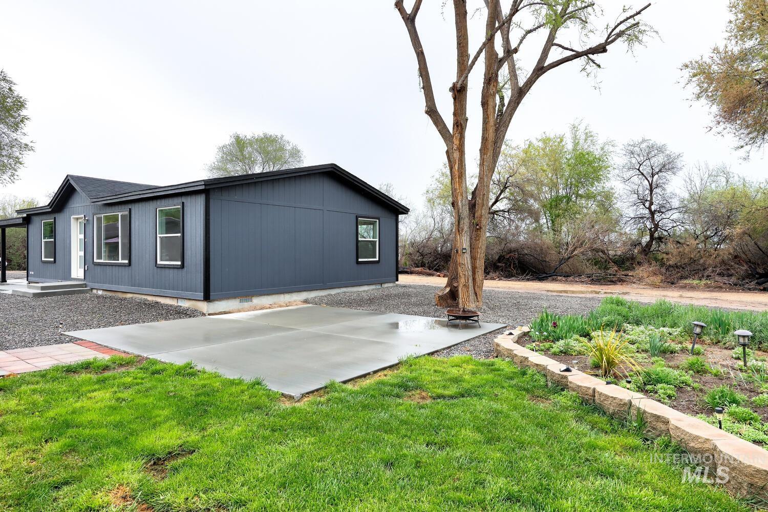 166 1st Street North Marsing, ID 83639 - Photo 31 of 37 View of property exterior with a patio, a lawn, and crawl space