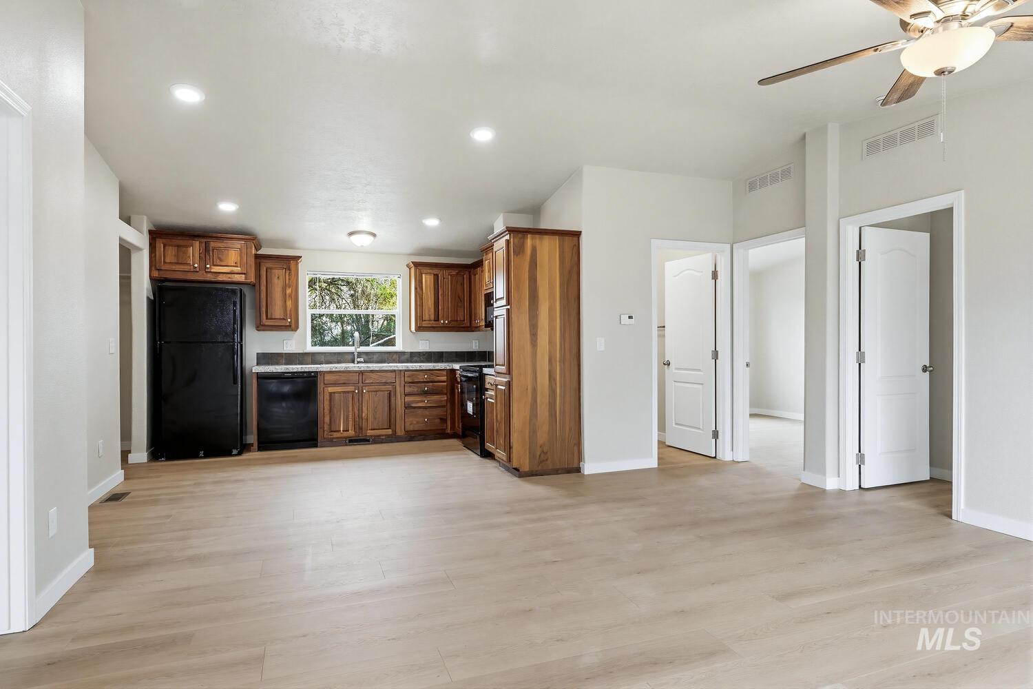 166 1st Street North Marsing, ID 83639 - Photo 10 of 37 Kitchen with black appliances, ceiling fan, recessed lighting, wood finish cabinets, and light wood-type flooring