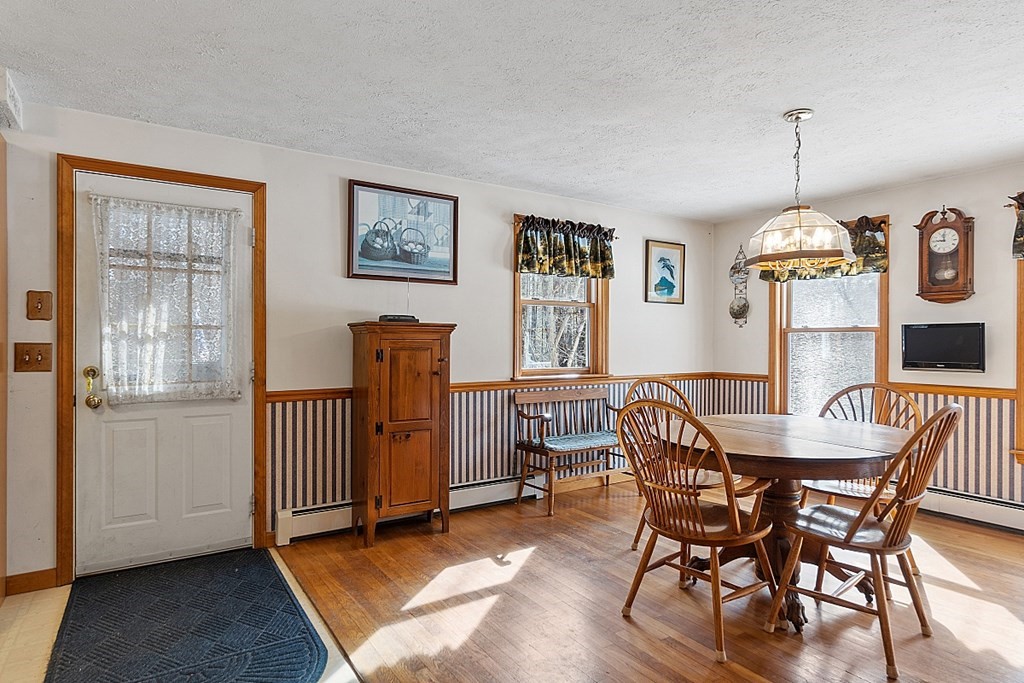 864 Foster Road Ashby, MA 01431 - Photo 11 of 41 a view of a dining room with furniture window and wooden floor