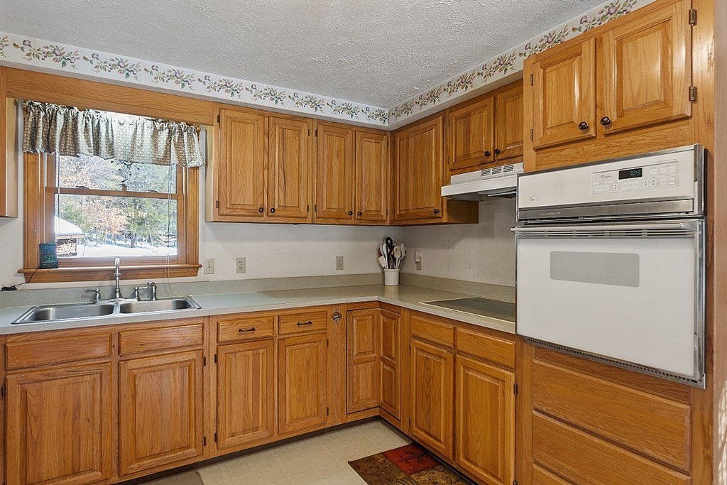 864 Foster Road Ashby, MA 01431 - Photo 13 of 41 a kitchen with stainless steel appliances granite countertop a sink a stove and cabinets