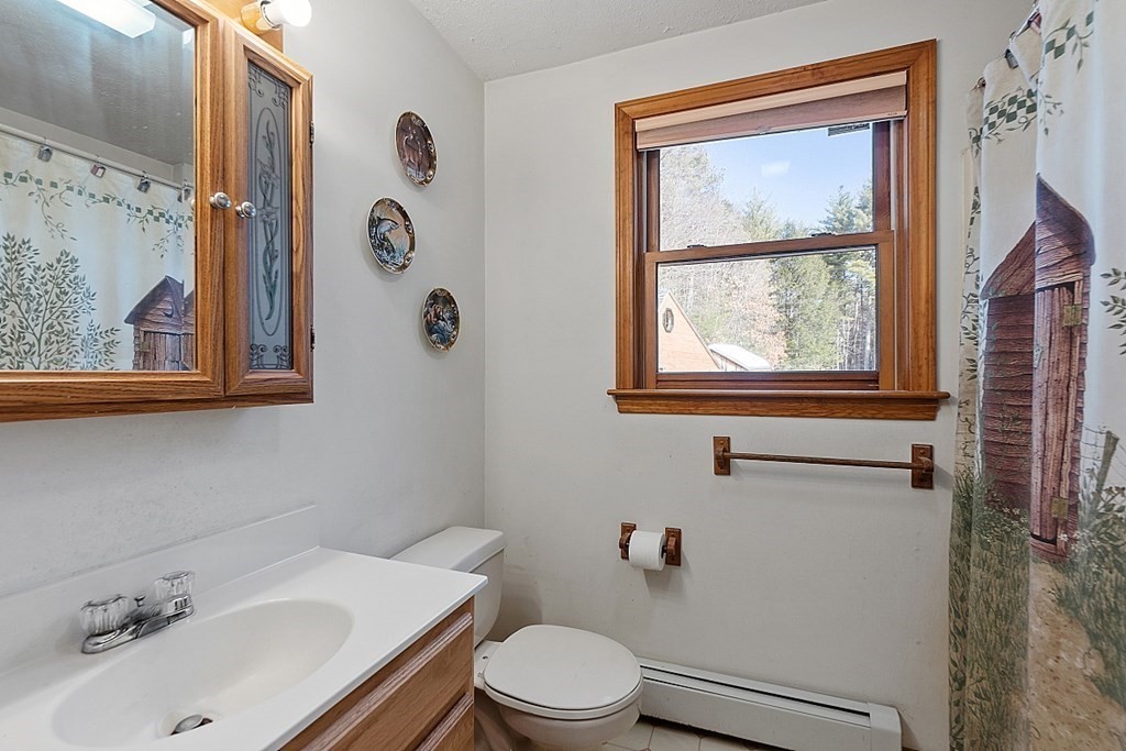 864 Foster Road Ashby, MA 01431 - Photo 15 of 41 a bathroom with a sink mirror and toilet