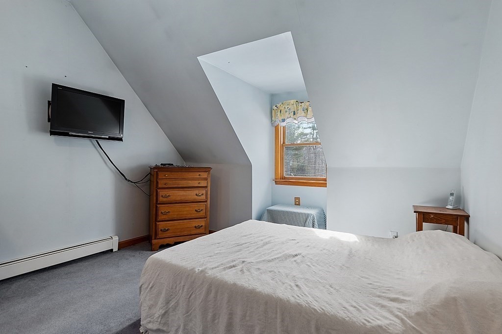 864 Foster Road Ashby, MA 01431 - Photo 19 of 41 a bedroom with a bed and a television