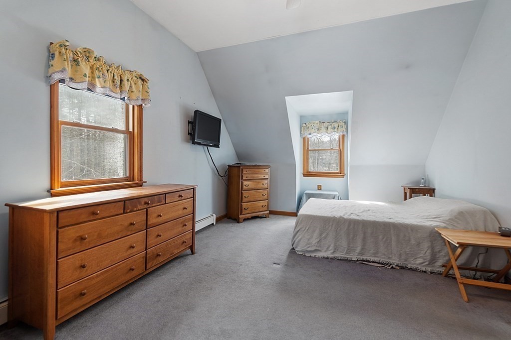 864 Foster Road Ashby, MA 01431 - Photo 20 of 41 a bedroom with a bed and a flat tv screen on dresser