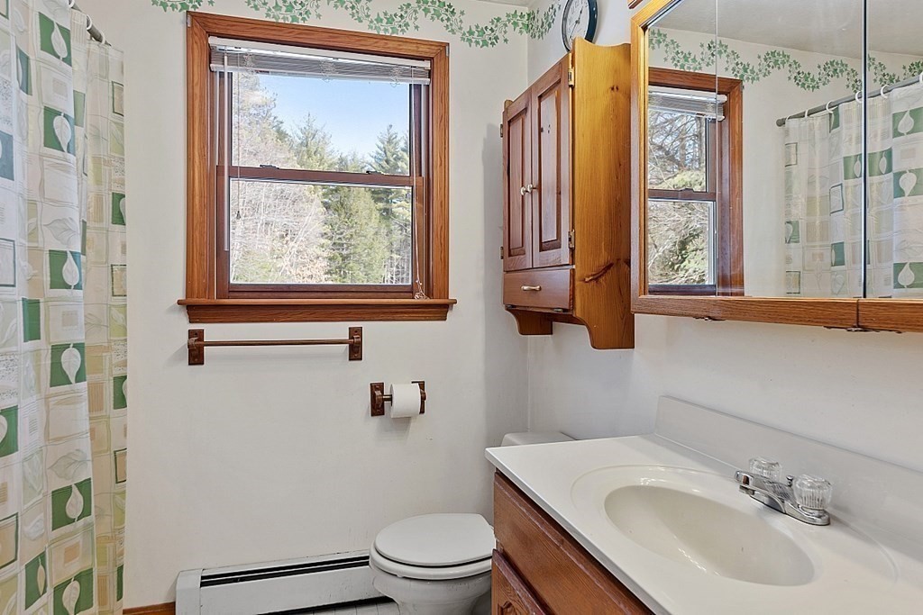 864 Foster Road Ashby, MA 01431 - Photo 22 of 41 a bathroom with a sink toilet and window
