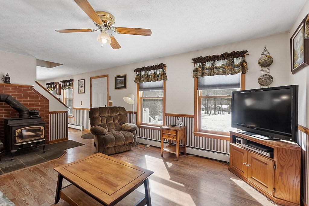 864 Foster Road Ashby, MA 01431 - Photo 3 of 41 a living room with furniture and a flat screen tv