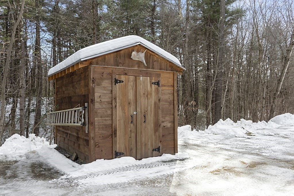 864 Foster Road Ashby, MA 01431 - Photo 34 of 41 a view of a house covered in snow