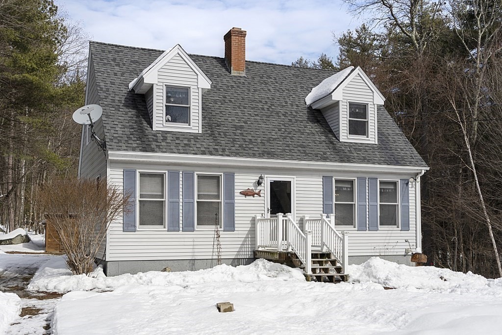 864 Foster Road Ashby, MA 01431 - Photo 37 of 41 a front view of a house with a yard covered in snow