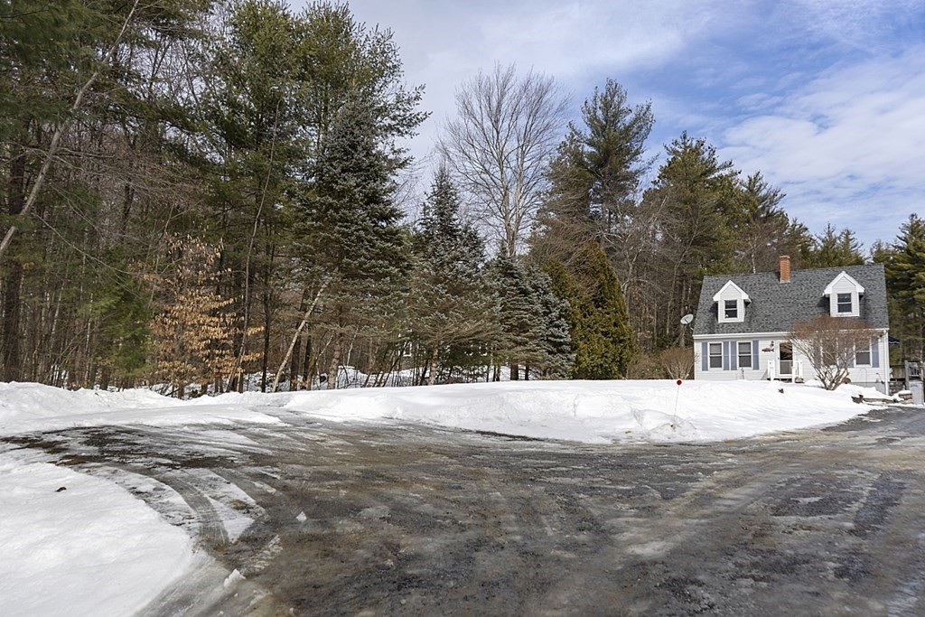 864 Foster Road Ashby, MA 01431 - Photo 38 of 41 a view of a white house with a snow on the road