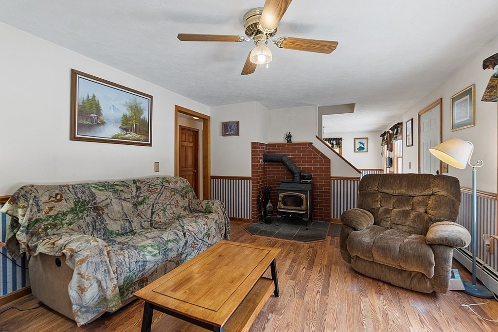 864 Foster Road Ashby, MA 01431 - Photo 6 of 41 a living room with furniture and a fireplace