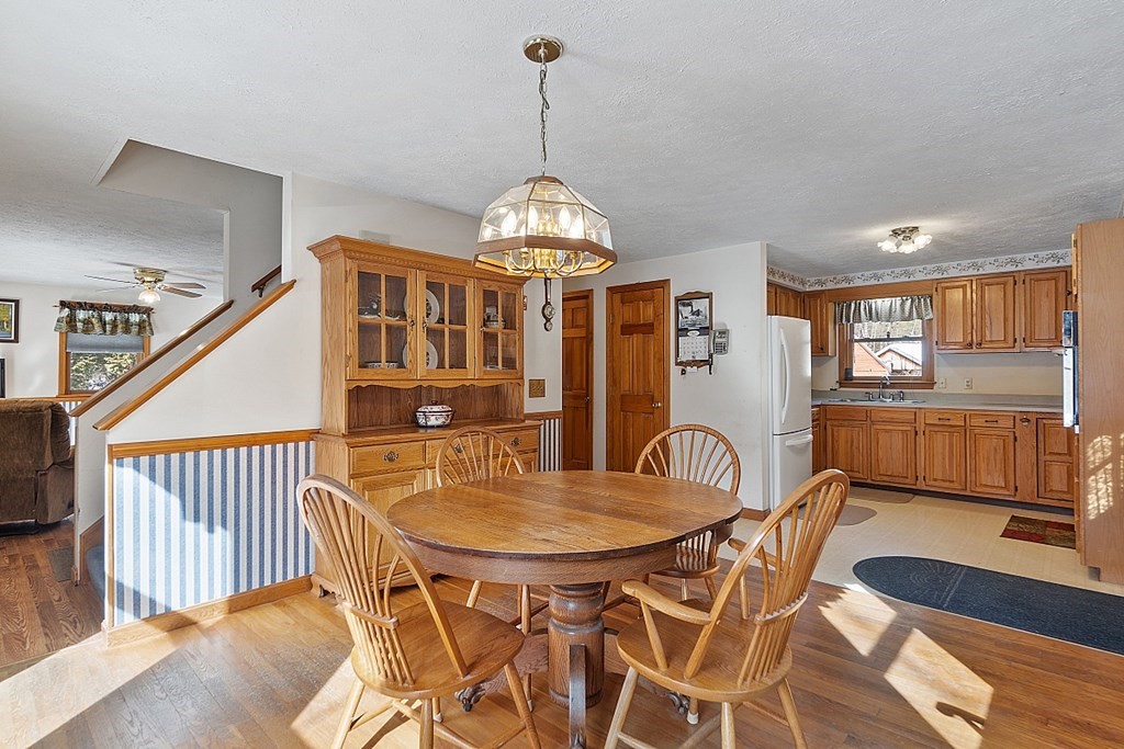 864 Foster Road Ashby, MA 01431 - Photo 8 of 41 a dining room with furniture a chandelier and wooden floor