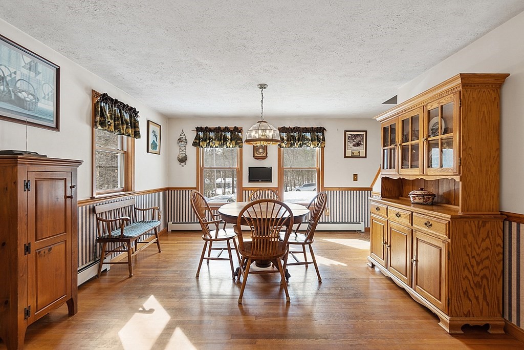 864 Foster Road Ashby, MA 01431 - Photo 10 of 41 a view of a dining room with furniture window and wooden floor