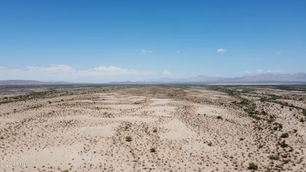 a view of a road with mountains in the background