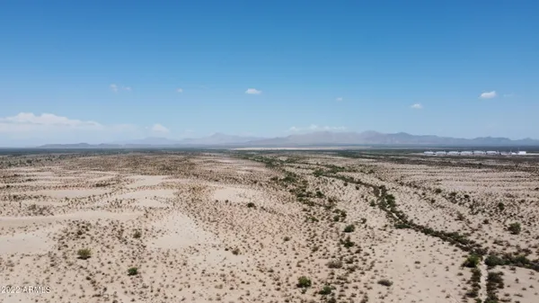 a view of a mountain range in a cloudy sky