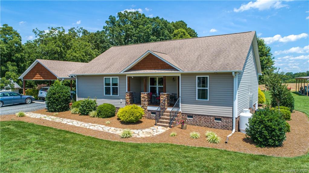 24376 Endy Road Albemarle, NC 28001 - Photo 1 of 27 a front view of a house with a yard outdoor seating and garage