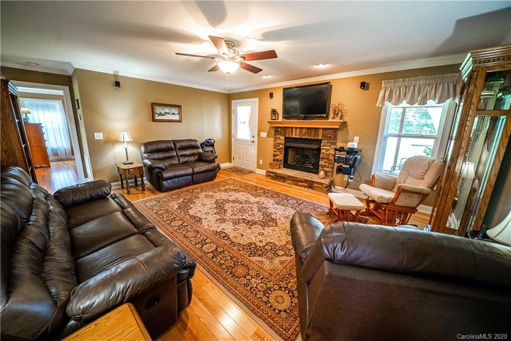 24376 Endy Road Albemarle, NC 28001 - Photo 12 of 27 a living room with furniture fireplace and a flat screen tv