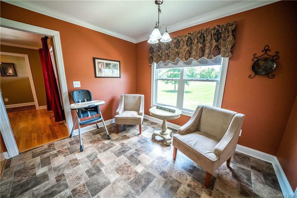 24376 Endy Road Albemarle, NC 28001 - Photo 13 of 27 a living room with furniture a window and a flat screen tv
