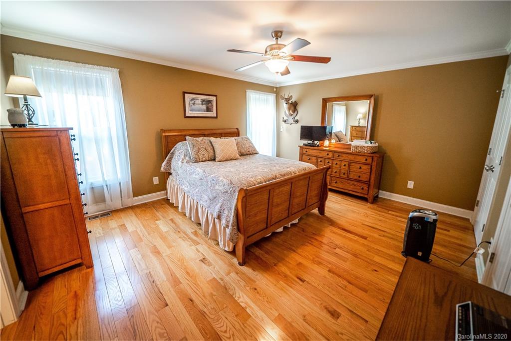 24376 Endy Road Albemarle, NC 28001 - Photo 19 of 27 a spacious bedroom with a bed and wooden floor