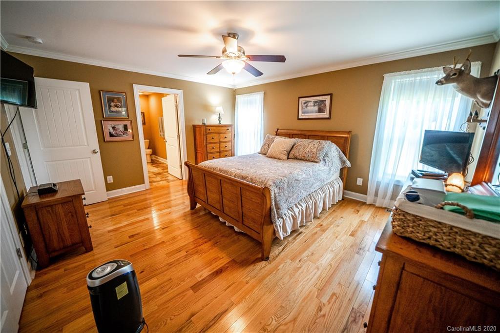 24376 Endy Road Albemarle, NC 28001 - Photo 20 of 27 a spacious bedroom with a bed and wooden floor