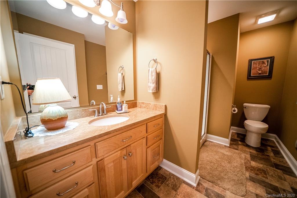 24376 Endy Road Albemarle, NC 28001 - Photo 21 of 27 a bathroom with double vanity sink and two mirror