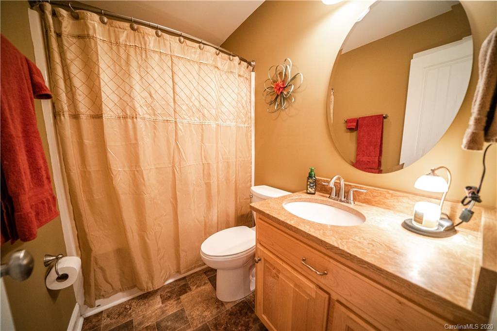 24376 Endy Road Albemarle, NC 28001 - Photo 24 of 27 a bathroom with a granite countertop sink and a mirror