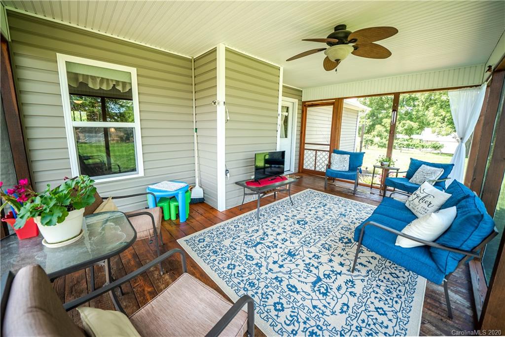 24376 Endy Road Albemarle, NC 28001 - Photo 26 of 27 a living room filled with furniture and a potted plant