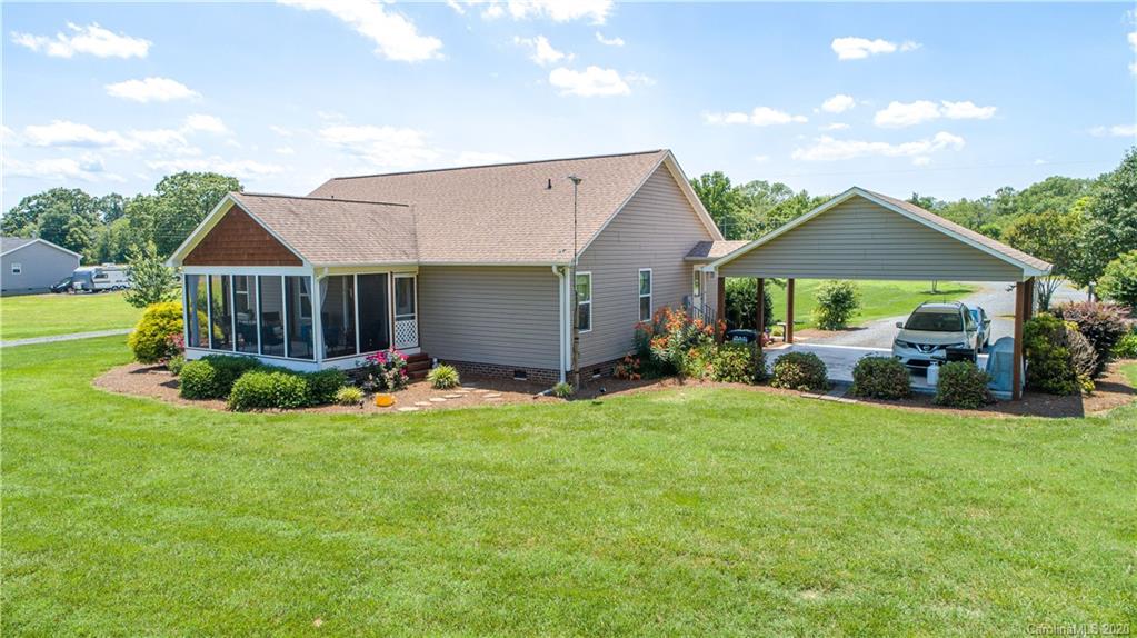 24376 Endy Road Albemarle, NC 28001 - Photo 5 of 27 a view of a house with a big yard and potted plants