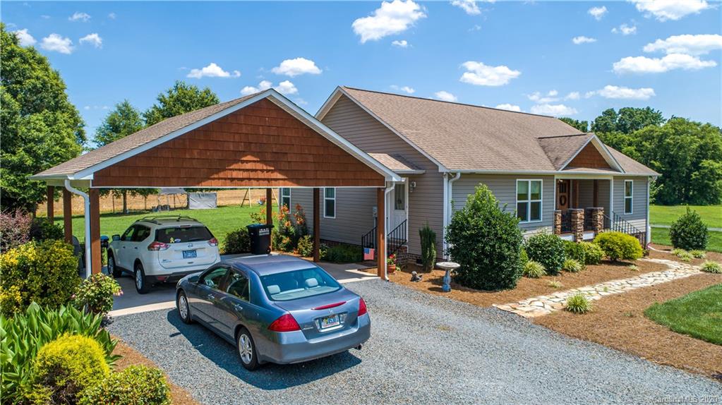 24376 Endy Road Albemarle, NC 28001 - Photo 8 of 27 a car parked in front of house with a yard