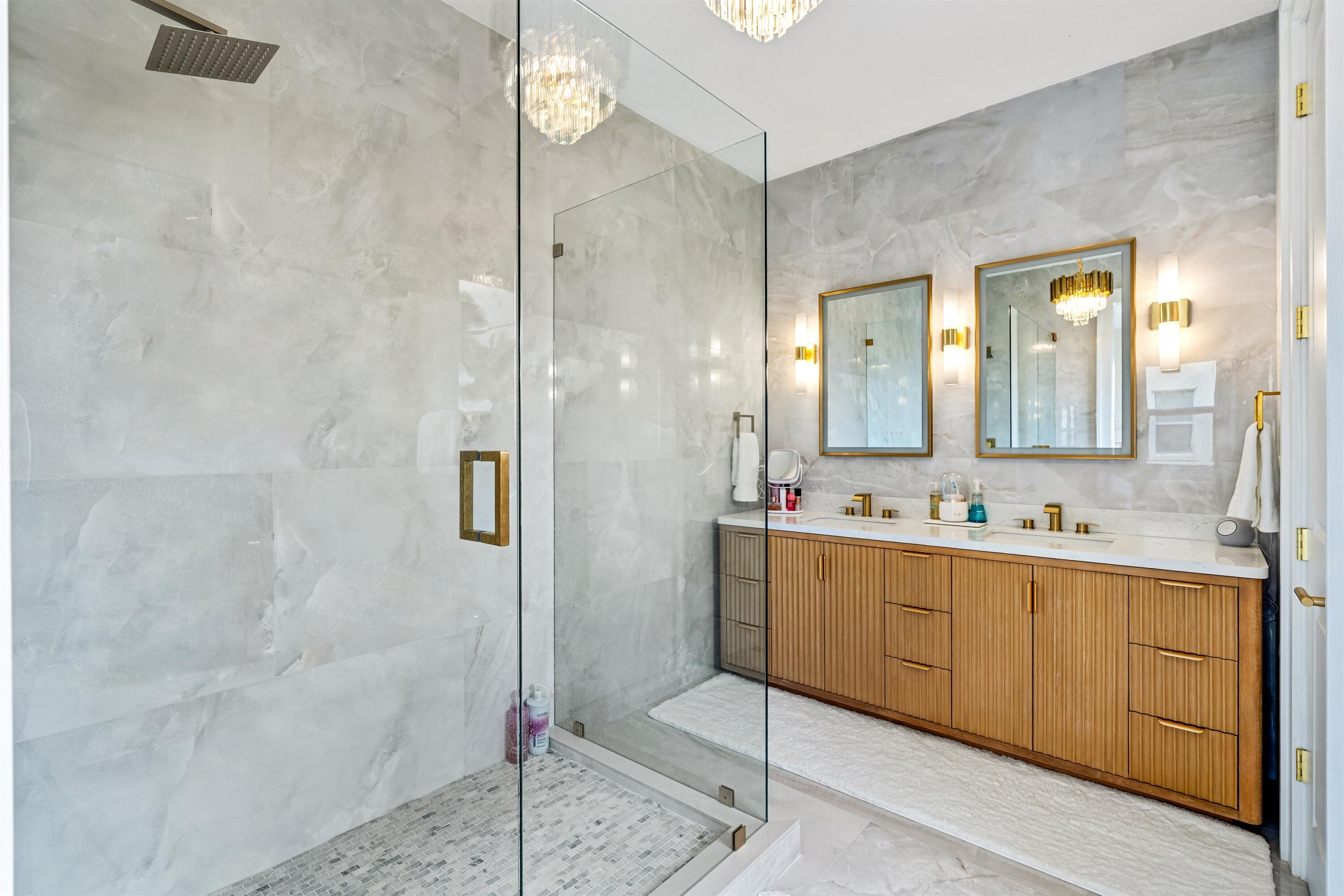 1570 Northwest 48th Place Boca Raton, FL 33431 - Photo 20 of 30 a bathroom with a double vanity sink mirror and shower