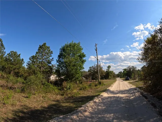 a view of a pathway with a wrought fence