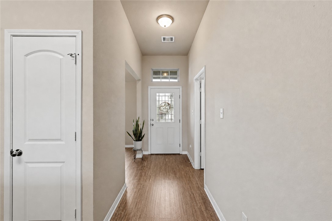 2725 Porter's Way Bryan, TX 77803 - Photo 4 of 19 a view of a hallway with wooden floor and closet