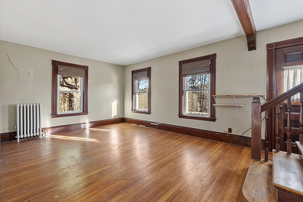 39 Terrace Street Orange, MA 01364 - Photo 12 of 40 a view of an empty room with wooden floor and a window