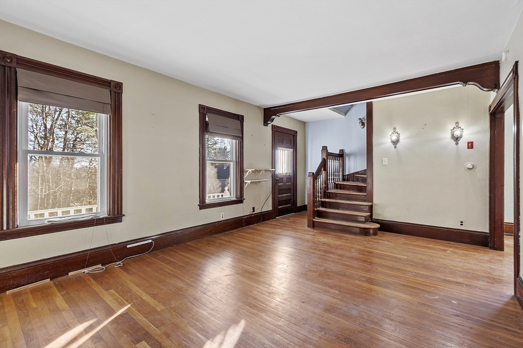 39 Terrace Street Orange, MA 01364 - Photo 13 of 40 an empty room with wooden floor and windows
