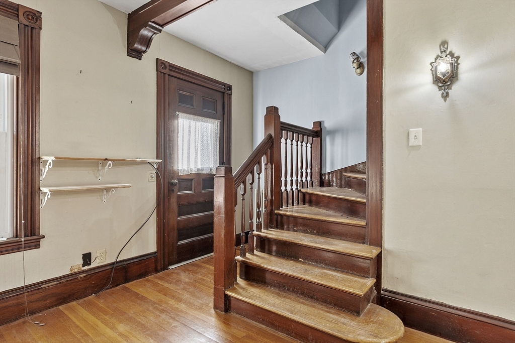 39 Terrace Street Orange, MA 01364 - Photo 15 of 40 a view of a hallway with wooden floor and staircase