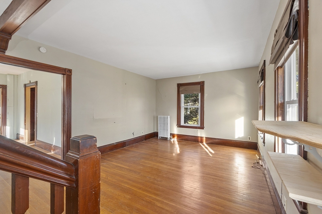 39 Terrace Street Orange, MA 01364 - Photo 16 of 40 a view of an empty room with wooden floor and a window