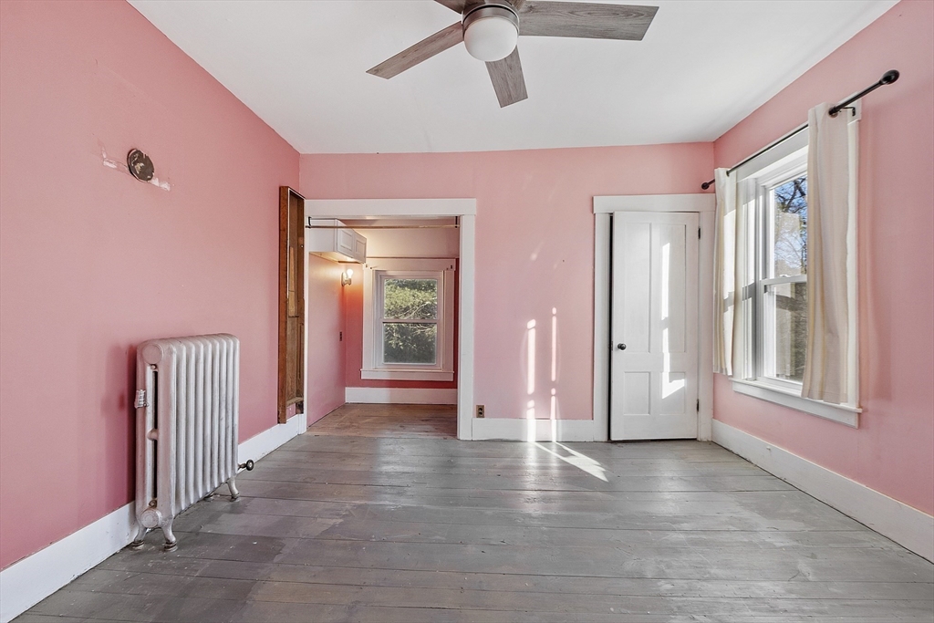 39 Terrace Street Orange, MA 01364 - Photo 24 of 40 a view of a livingroom with wooden floor and a ceiling fan