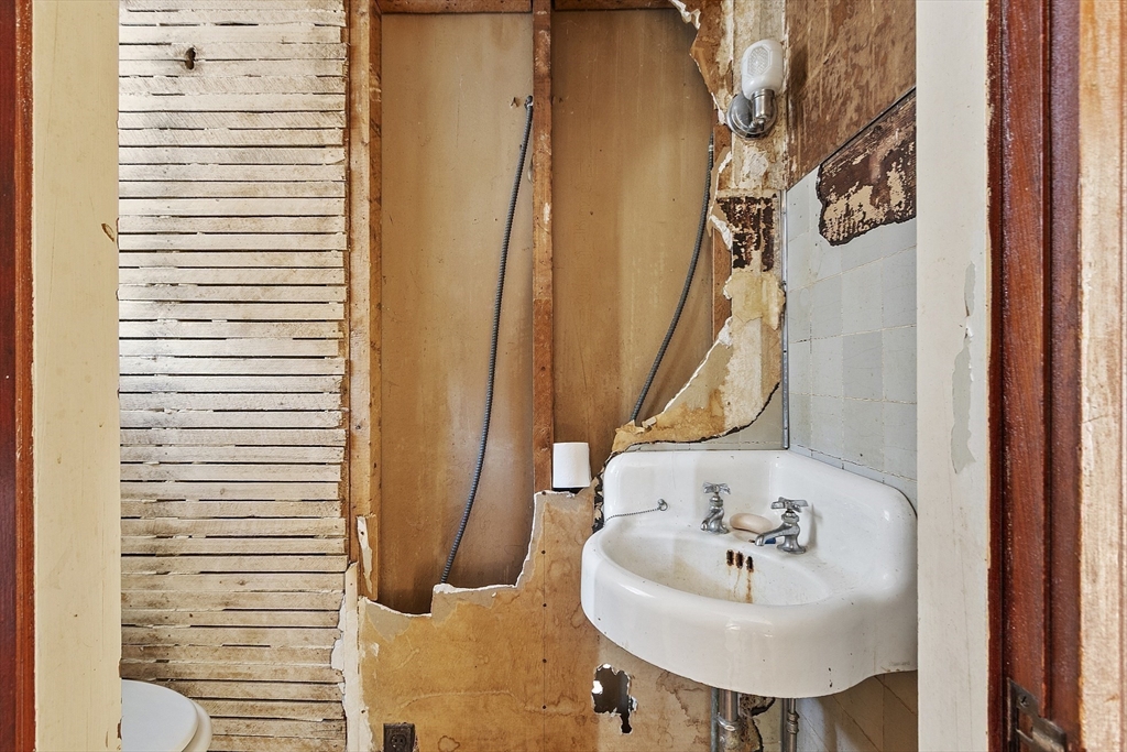 39 Terrace Street Orange, MA 01364 - Photo 28 of 40 a bathroom with a sink toilet and a mirror