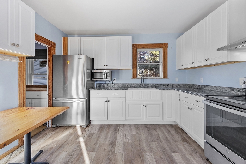 39 Terrace Street Orange, MA 01364 - Photo 3 of 40 a kitchen with appliances a sink cabinets and a window