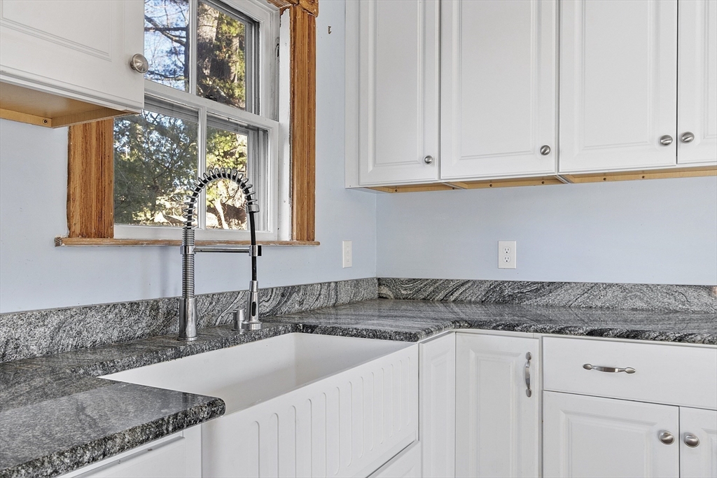 39 Terrace Street Orange, MA 01364 - Photo 4 of 40 a kitchen with granite countertop a sink a stove and cabinets
